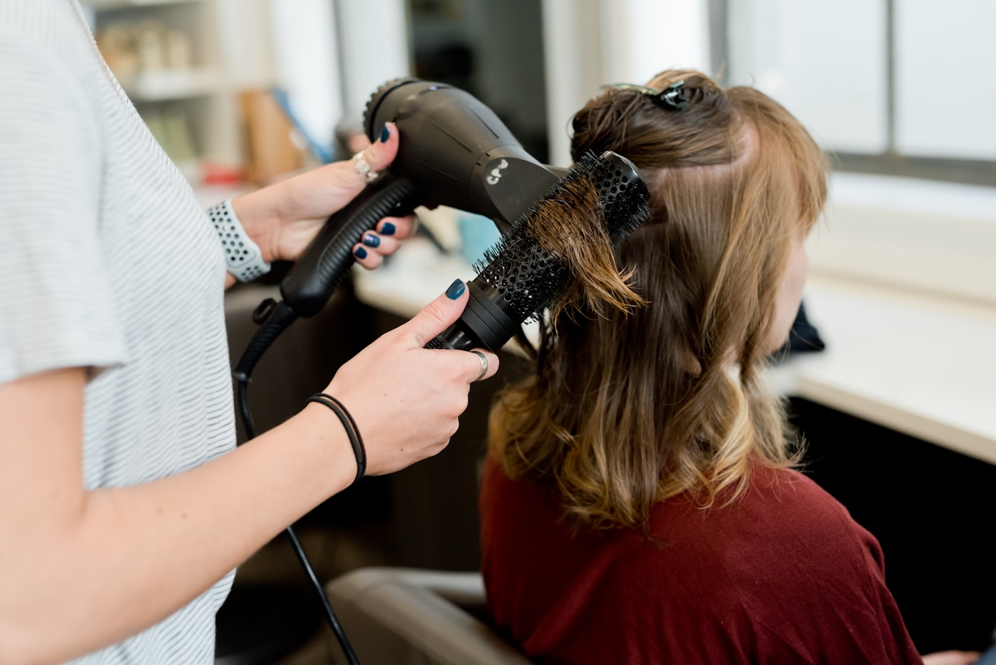 Stylist finishing a soft blowout